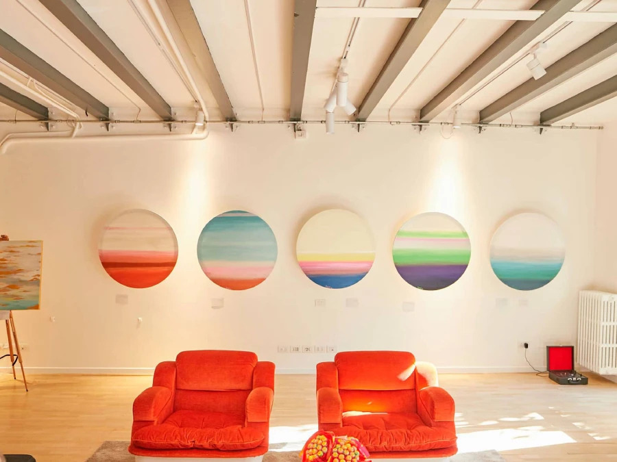 Installation view of circular paintings by Rosana Auqué from the FUN exhibition at P’n’P Communication, Milan 2022