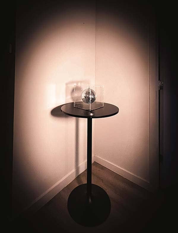 Installation view – The Moon sculpture displayed at Art Basel Miami Installation view of The Moon by Rosana Auqué, placed on a round pedestal within a corner-lit space.